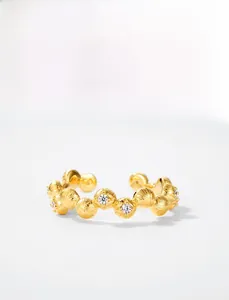 Macro detail of gold plated vine ring showing brushed texture and sparkling zircon bud