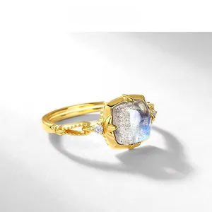 Macro detail of gold-plated silver ring with square labradorite and white side stones