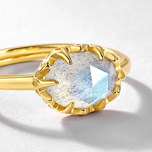 Macro shot of 18K gold plated silver ring with a faceted blue moonstone gemstone