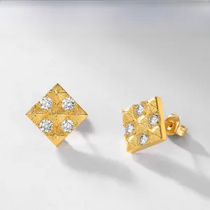 Macro shot of square S925 sterling silver gold-plated stud earrings with four zircons