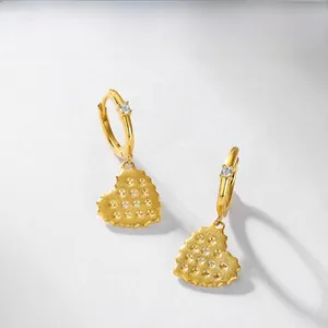Macro detail of gold-plated heart earring with matte finish and micro-inlaid S925 mark