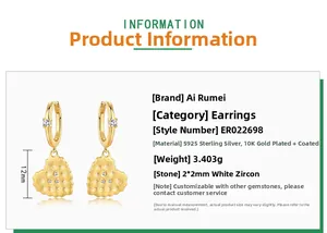 Detail of heart-shaped gold earrings with brushed texture and white zircon inlay