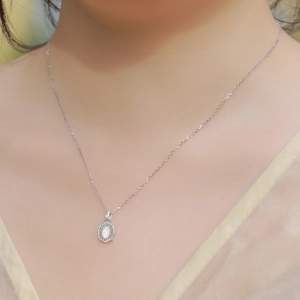 Elegant S925 sterling silver necklace with oval synthetic opal pendant on female model