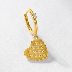 Detailed view of gold heart earrings featuring S925 silver hallmark and pavé stones