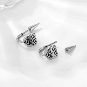 Detailed view of punk gothic palm and evil eye stud earrings with screw back cone design