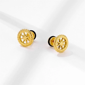 Detail of golden stainless steel stud earrings featuring an octagonal star with rim relief