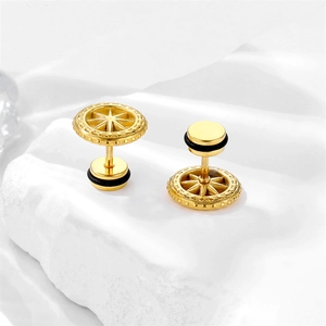 Macro shot of gold stainless steel stud earrings featuring an engraved starburst pattern
