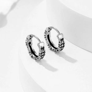 Vintage hollow titanium steel hoop earrings with detailed gothic carved patterns