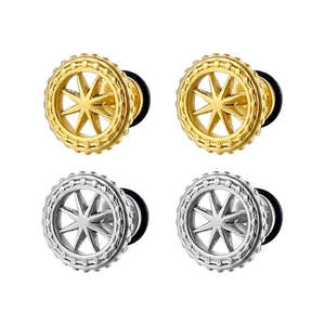 Detailed macro view of gold and silver stainless steel star pattern ear gauges with rubber rings