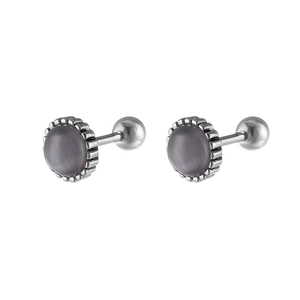 Close-up of vintage stainless steel stud earrings with purple cat eye stones