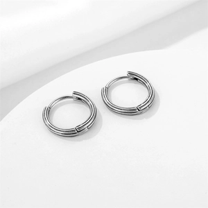 Sleek silver stainless steel hoop earrings with double grooved lines in a minimalist style