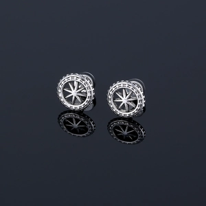 Polished stainless steel stud earrings with compass star pattern on black mirror base