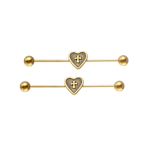 Detail of two golden industrial barbells featuring heart shapes and cross patterns