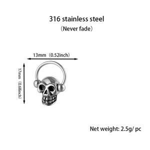 Macro detail of punk skull earring in 316L stainless steel with vintage silver finish