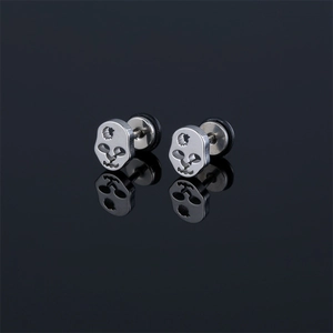 Stainless steel skull stud earrings with matte finish on black reflective background