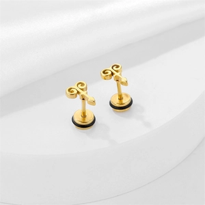 Golden stainless steel hoop earrings with unique symbolic charm on a minimalist display