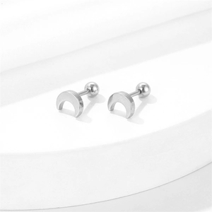 Minimalist silver crescent moon stud earrings with screw ball back closure on white stand