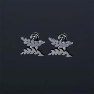 Vintage stainless steel leaf stud earrings with silver feather design on a mirror surface