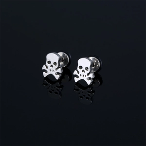 Polished stainless steel skull stud earrings with bone cross on a black mirror background