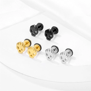 Three pairs of stainless steel flaming skull stud earrings in gold, silver, and black