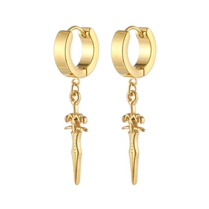 Detailed view of vintage gold sword charm earrings with ornate engraving on white background