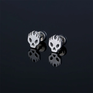 Gothic silver stainless steel skull stud earrings with flame pattern on black background