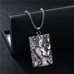 Detailed macro view of vintage relief pendant with box chain and ethnic pattern