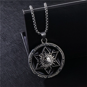 Détail macro du médaillon argenté avec hexagramme et runes gravées sur fond noir
