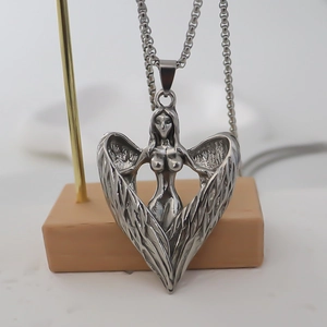 Detailed view of silver stainless steel angel heart pendant with intricate carved wings