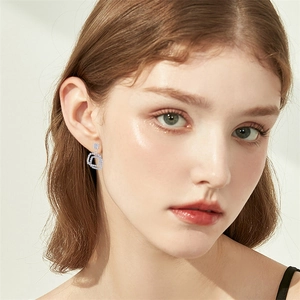 Geometric square double-hoop silver earrings with pave-set zircon for women worn by a model