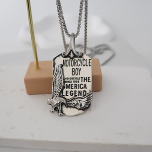Vintage silver eagle embossed square pendant necklace on minimalist display