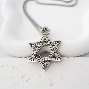Vintage silver Hexagram pendant necklace with engraved floral motifs on a white stone background