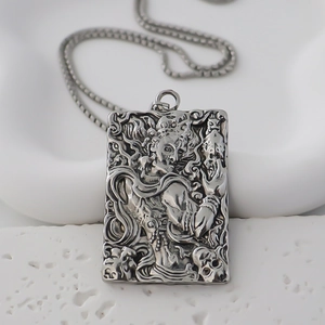 Retro stainless steel rectangle pendant necklace featuring embossed mythological totem carving
