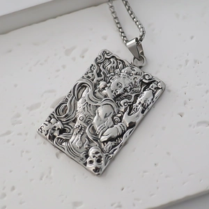 Detailed relief of rectangular pendant with skull and clouds on box chain necklace