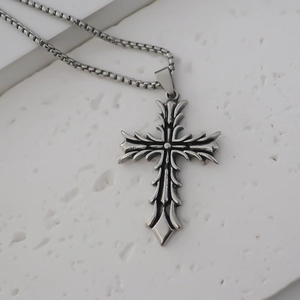 Detail view of gothic stainless steel cross pendant with vintage matte finish on stone