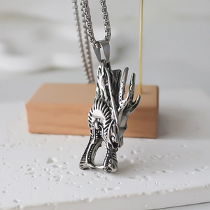 Detailed close-up of a silver dragon totem pendant with punk style metal chain