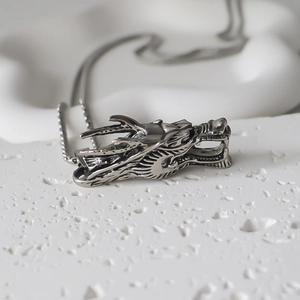 Vintage silver dragon head pendant necklace with intricate scales on a metal link chain