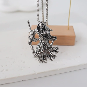 Detailed close-up of retro silver Grim Reaper pendant with scythe on box chain