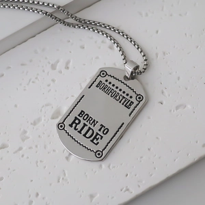 Close-up of industrial style silver military dog tag necklace with engraved texture