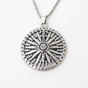 Vintage compass pendant necklace in silver with fleur-de-lis detail on white background
