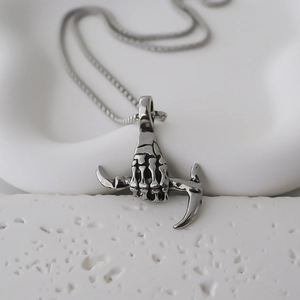 Vintage stainless steel skeleton hand holding a pickaxe pendant on metal chain necklace