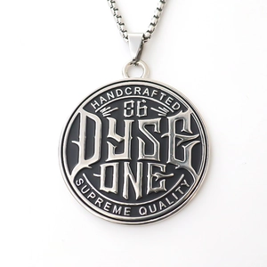 Macro shot of silver Dyse One pendant with handcrafted engraving and box chain