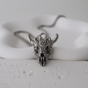 Detail of silver bull skull pendant with hexagram engraving on punk style chain
