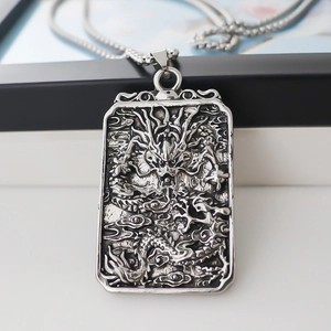 Silver square pendant necklace featuring an embossed dragon in a vintage punk style