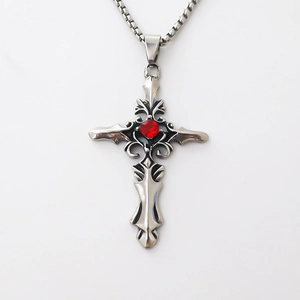 Gothic silver cross necklace with a red gemstone pendant and vintage engraved details