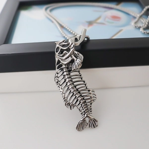 Silver fish bone skeleton pendant necklace with sleek snake chain for a gothic street style