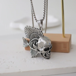 Gothic skull fish bone pendant necklace in silver stainless steel on display