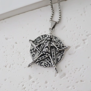 Close-up of gothic stainless steel pentagram skull pendant with vintage rune engraving