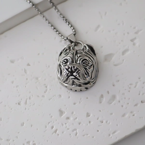 Detailed close-up of a vintage bulldog head pendant with intricate metallic textures