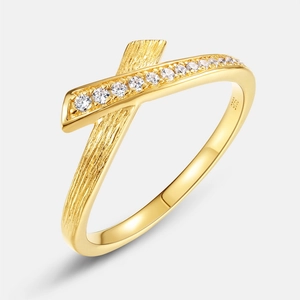 Crossed golden S925 silver ring featuring brushed texture and white zircon stones